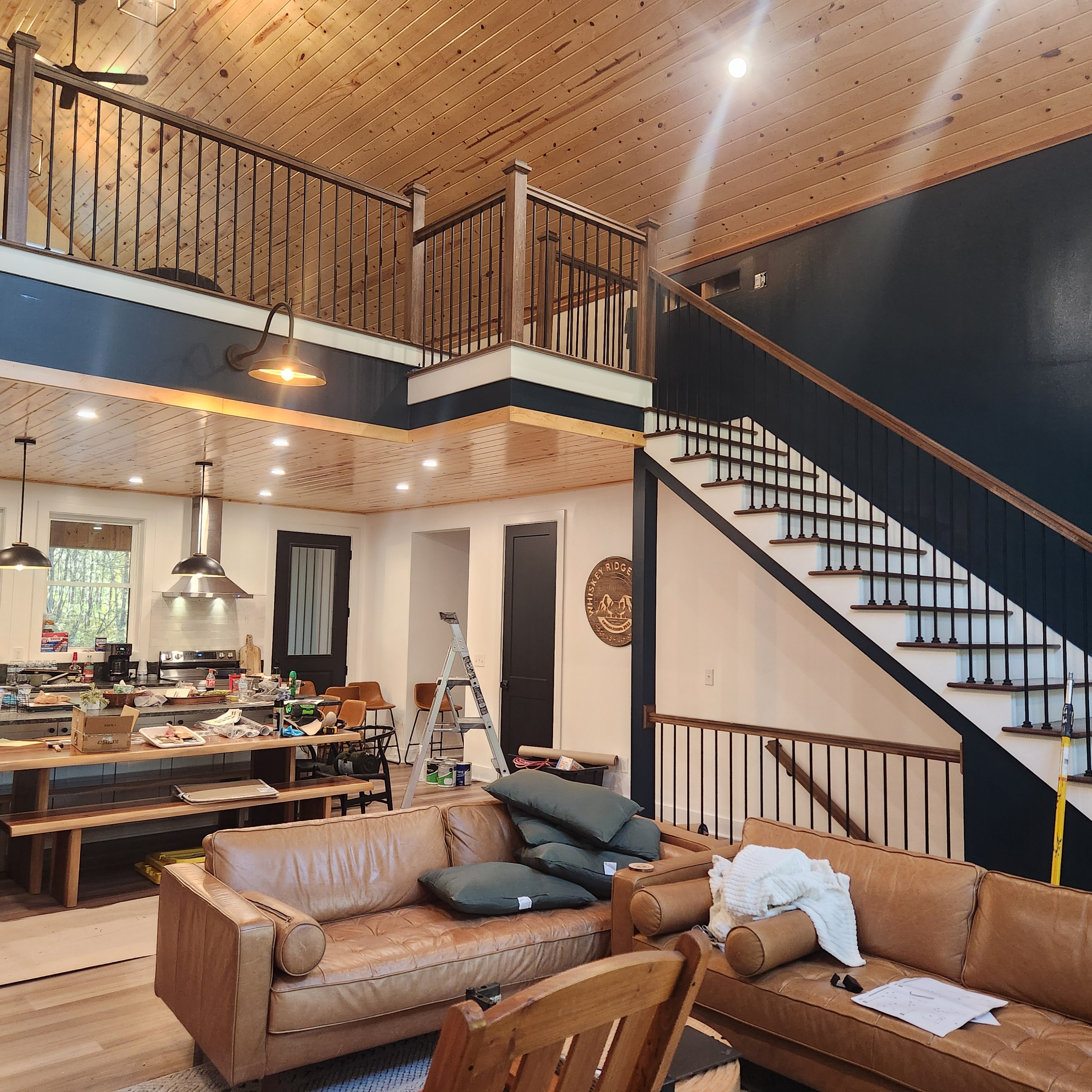 Lower-level renovation with leather seating, custom shelving and bar area